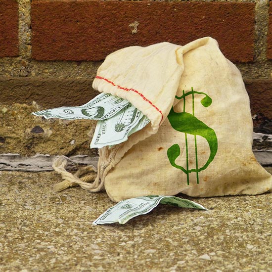 bag of money next to brick wall