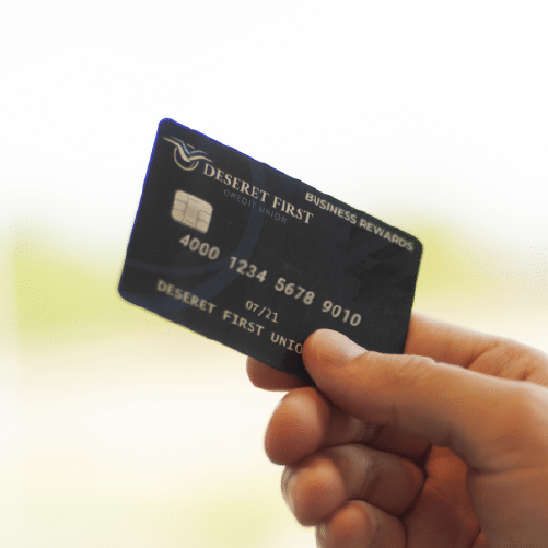 close up of a hand holding a credit card, shallow depth of focus