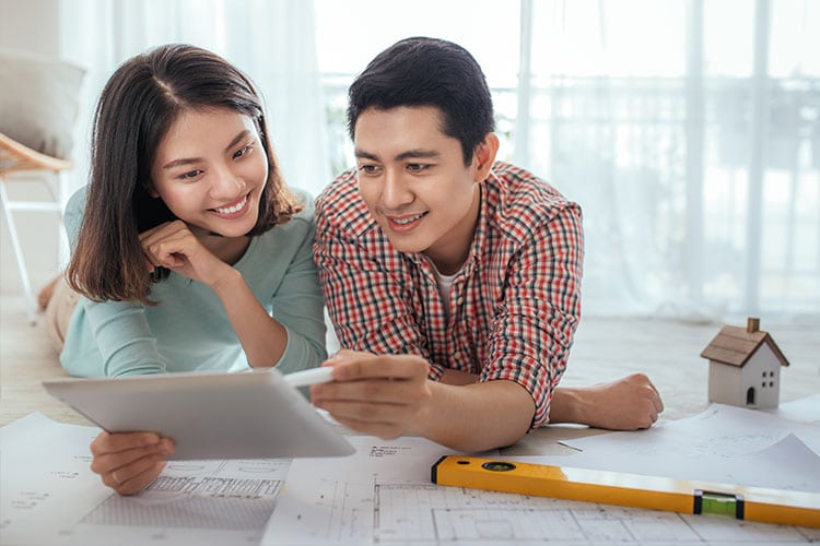 couple reviewing architectural plans for their new house