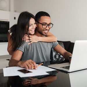 young couple looking at their finances online