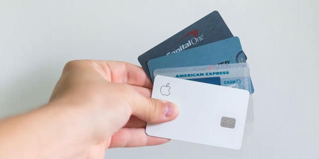 A hand fanning out several different credit cards