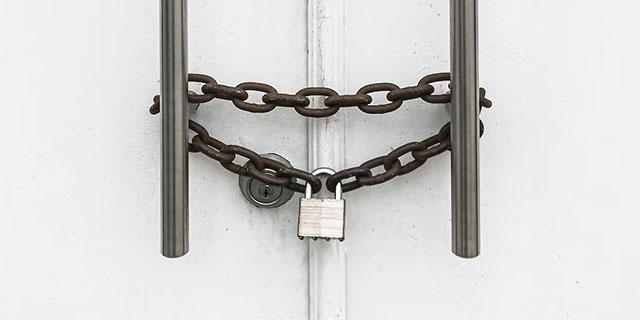 a double door secured with a lock and chain