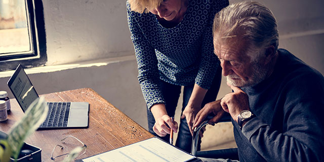 Elderly couple reviewing life insurance documents